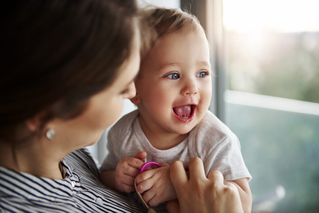 Mother holding smiling baby