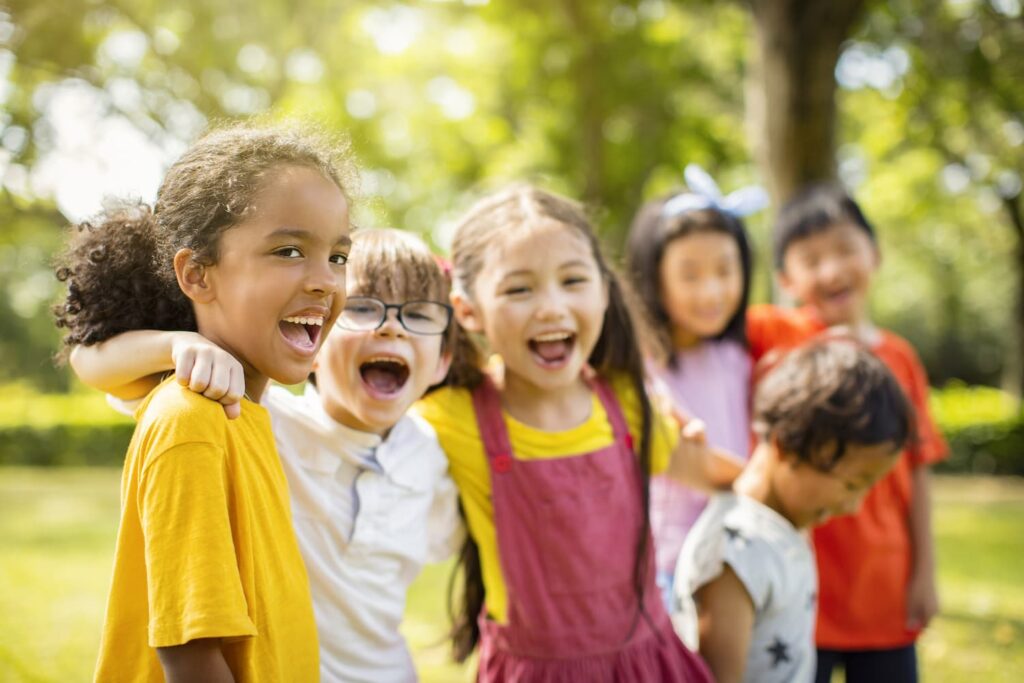 A group of children laughing and smiling